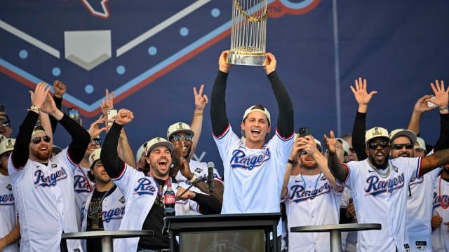 Texas Rangers shortstop Corey Seager raises the Commissioner's Trophy during the team's World Series championship celebration outside Globe Life Field on Nov. 3.